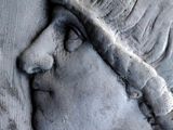 a statue of a woman wearing a headdress on the side of a building