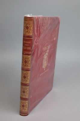 an old book sitting on top of a white table