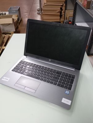 a laptop computer sitting on a table in a warehouse