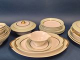 a lot of plates and bowls that are on a table