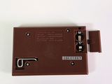 a close up of a brown electronic device on a white surface