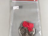 a picture of a silver plate with a red bow on it