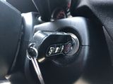a close up of a car key in the center of the steering wheel