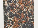 a book with a black cover and orange and white paint splattered on it