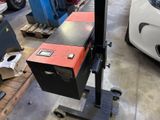 a machine that is sitting on a cart in a garage