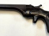 a gun that is on a table with a white background