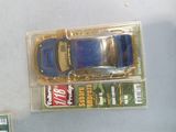 a blue toy car in a clear box on a table
