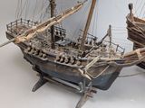 a wooden model of a boat on display on a table