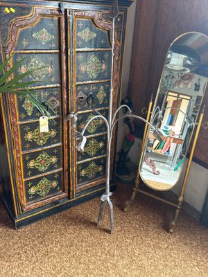 a tall cabinet with a mirror and a mirror on it