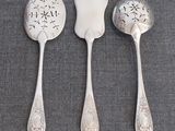 three spoons that are sitting on a table