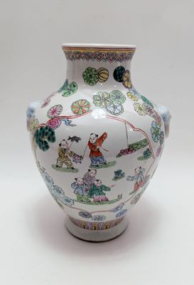 a white vase with a design on it on a white surface