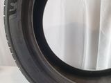 a close up of a tire on a table with a white background