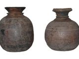two vases sitting next to each other on a white surface