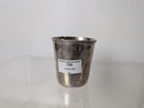 a silver cup sitting on a table with a label on it