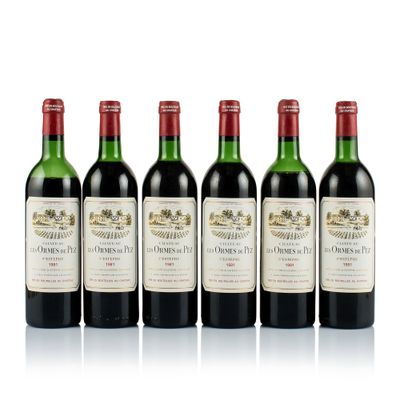 four bottles of wine are lined up on a white surface