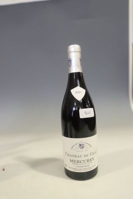 a bottle of wine sitting on a counter in a kitchen