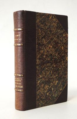 an old book with a brown cover sitting on top of a white surface