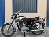 a motorcycle parked on the sidewalk in front of a building