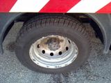 a close up of a tire on a red and white truck