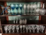 a wooden shelf with many glasses and glasses on it