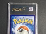 the pokemon card is in a plastic holder on a table