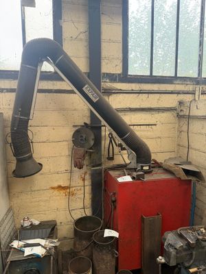 a large pipe sticking out of the wall of a building