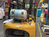 a yellow forklift truck parked in a warehouse