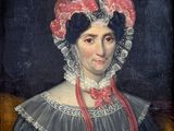 portrait of a woman in a black dress with a red and white bonnet