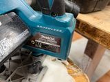 a close up of a circular saw on a piece of wood