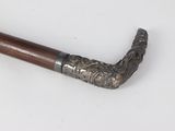 an old pipe with a wooden handle on a white surface