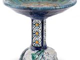 a blue and green bowl with a bird on it