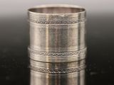 a close up of a silver ring on a black surface