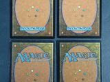four decks of magic the gathering deck are shown on a table