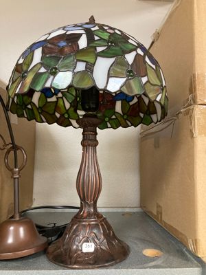 a lamp that is sitting on a shelf next to a lamp