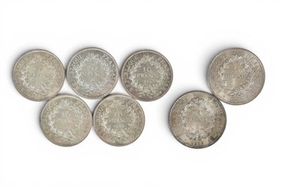 six different types of silver coins on a white surface