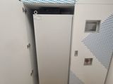 a white refrigerator in the corner of a room
