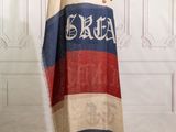 an image of a red, white, and blue scarf on a mannequin stand