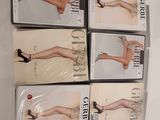 four pairs of women ' s tight stockings are on display in a display case