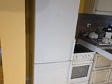a kitchen with a refrigerator, stove, sink, and microwave in it