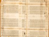 an old book with a torn page on top of it