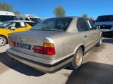 a silver car parked in a parking lot with other cars