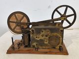 an old fashioned sewing machine sitting on top of a white table