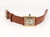 a close up of a wrist watch with a brown strap