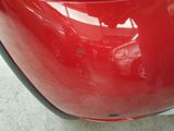 a close up of a red car ' s rear bumper