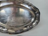 a silver tray on a table with a spoon on it