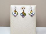 a close up of a pair of earrings on a display stand