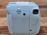 a small camera sitting on a table with a tag on it