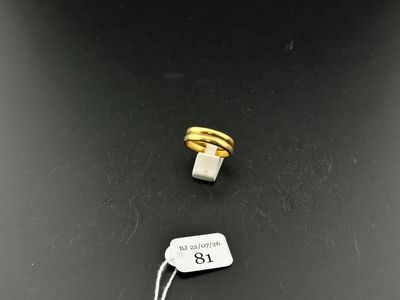 a close up of a ring and a tag on a table