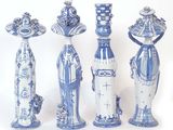 several blue and white vases are lined up on a white surface