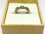 an image of a diamond and emerald ring in a box